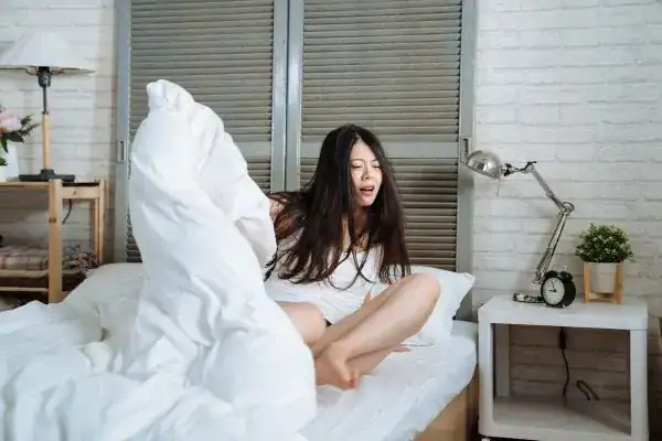 Image of woman getting up because of nighttime leaks